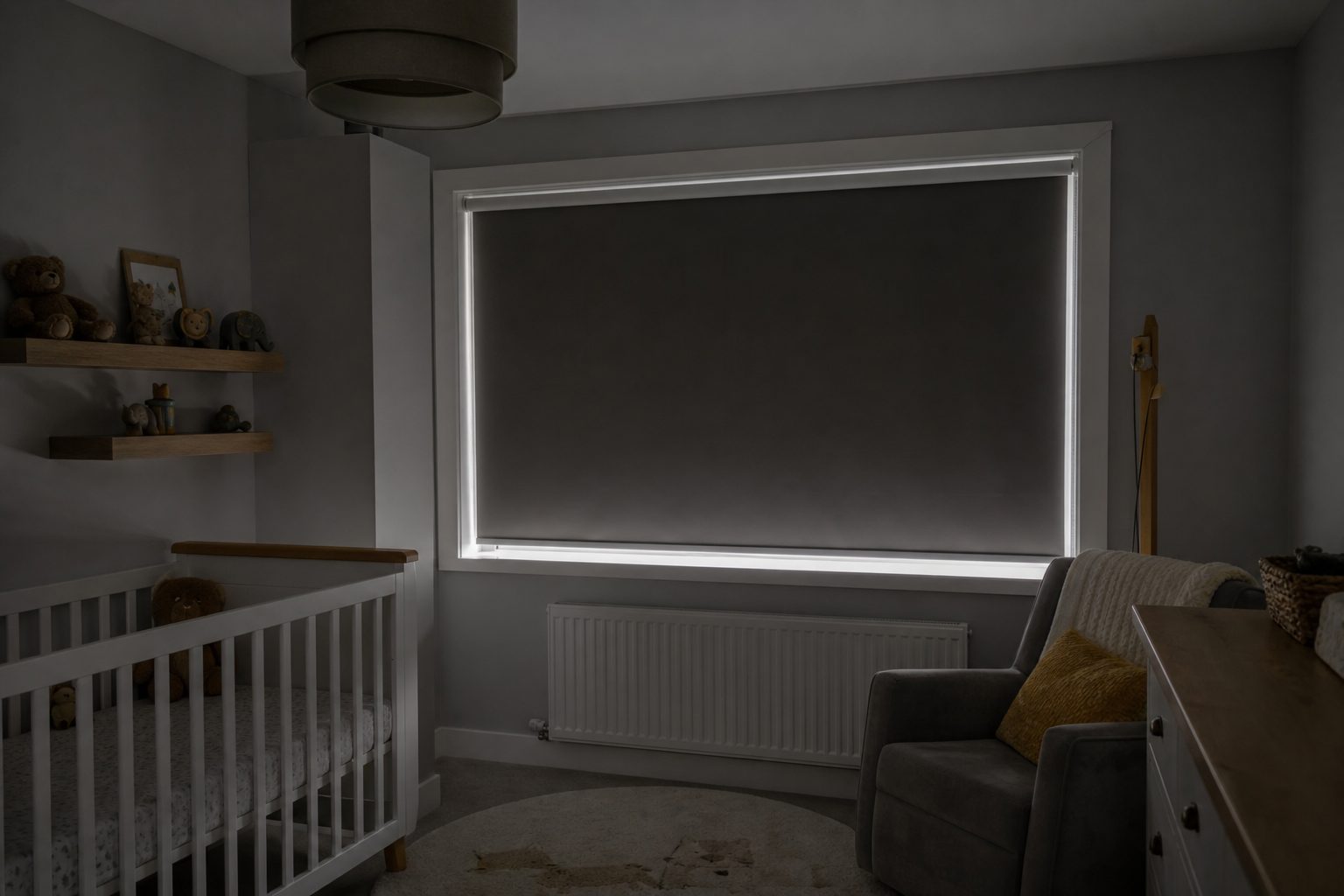 Blackout roller blind lowered in a darkened nursery